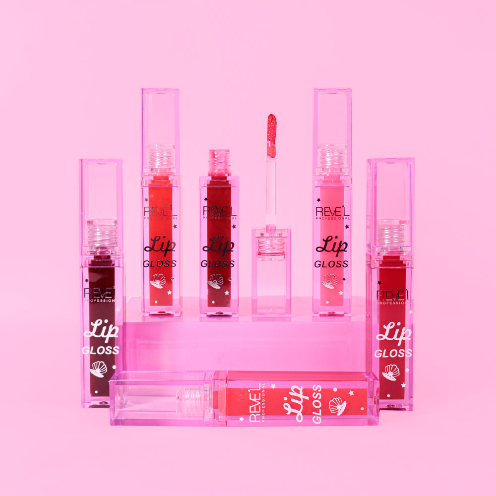 Lip gloss brillante Reve'l Professional con empaque traslúcido estampado de concha marina, 6 tonos desde rosa suave y fucsia hasta rojo y vino intenso, sobre fondo rosa