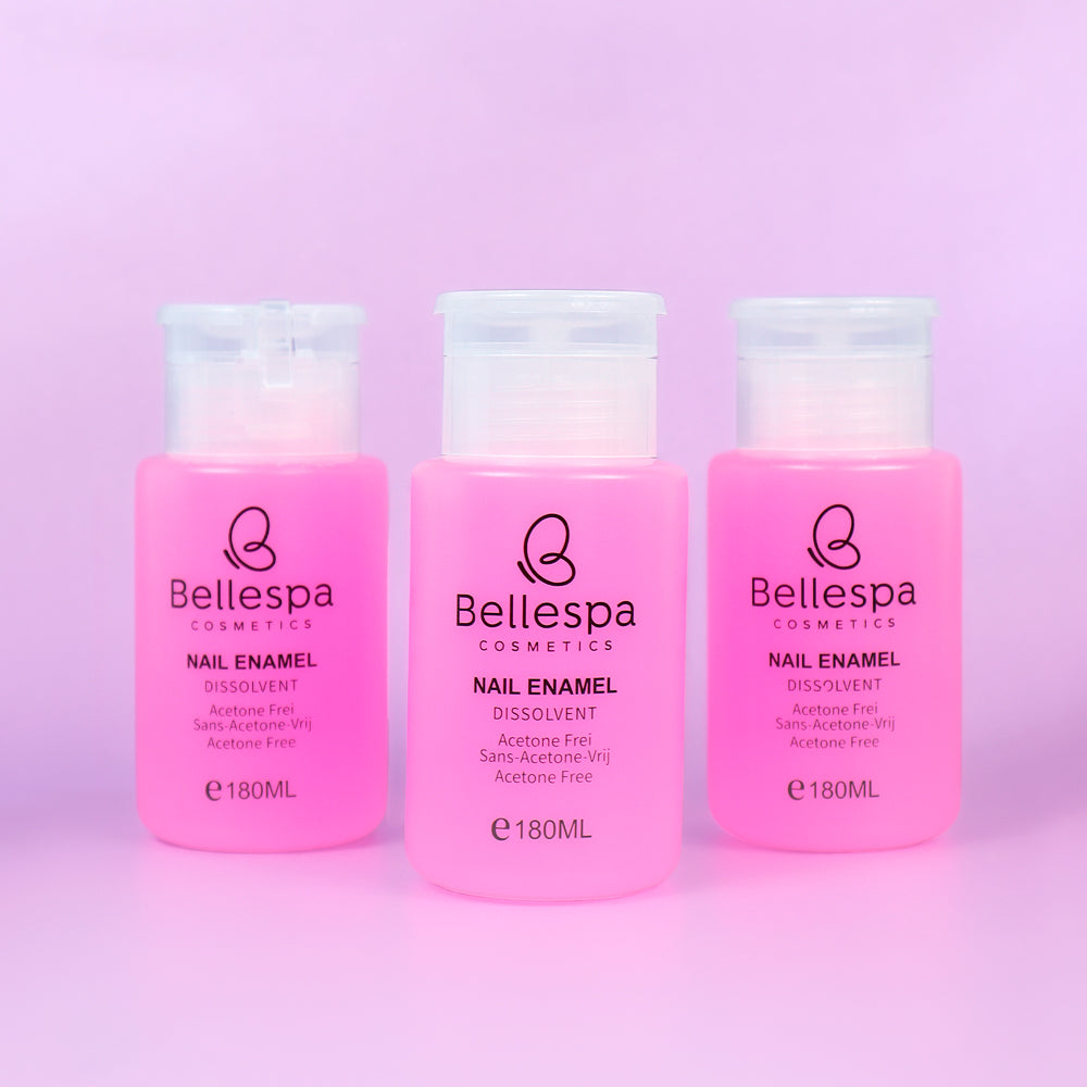 Removedor de esmalte Nail Enamel Dissolvent Acetone Free Bellespa Cosmetics en envase rosa con dispensador 180ml sobre fondo lila