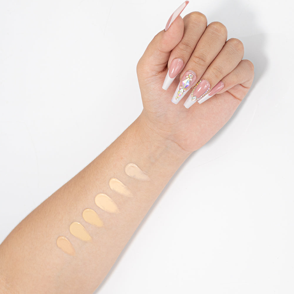 Swatches de 6 tonos de base líquida crema rosa aplicados en brazo — Reve'l Professional 43 ml