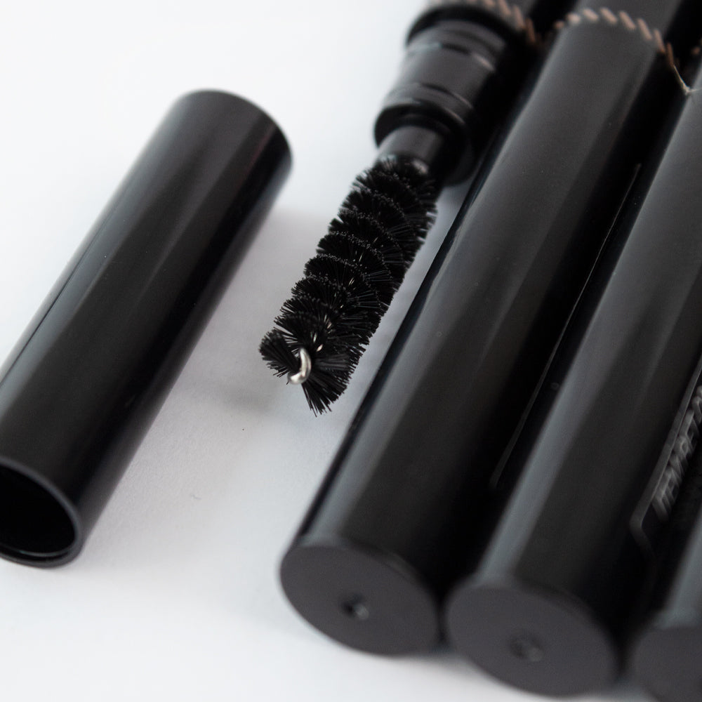 Close-up of Revel Professional Brow Natural Duo spoolie brush tip on white background
