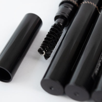 Close-up of Revel Professional Brow Natural Duo spoolie brush tip on white background