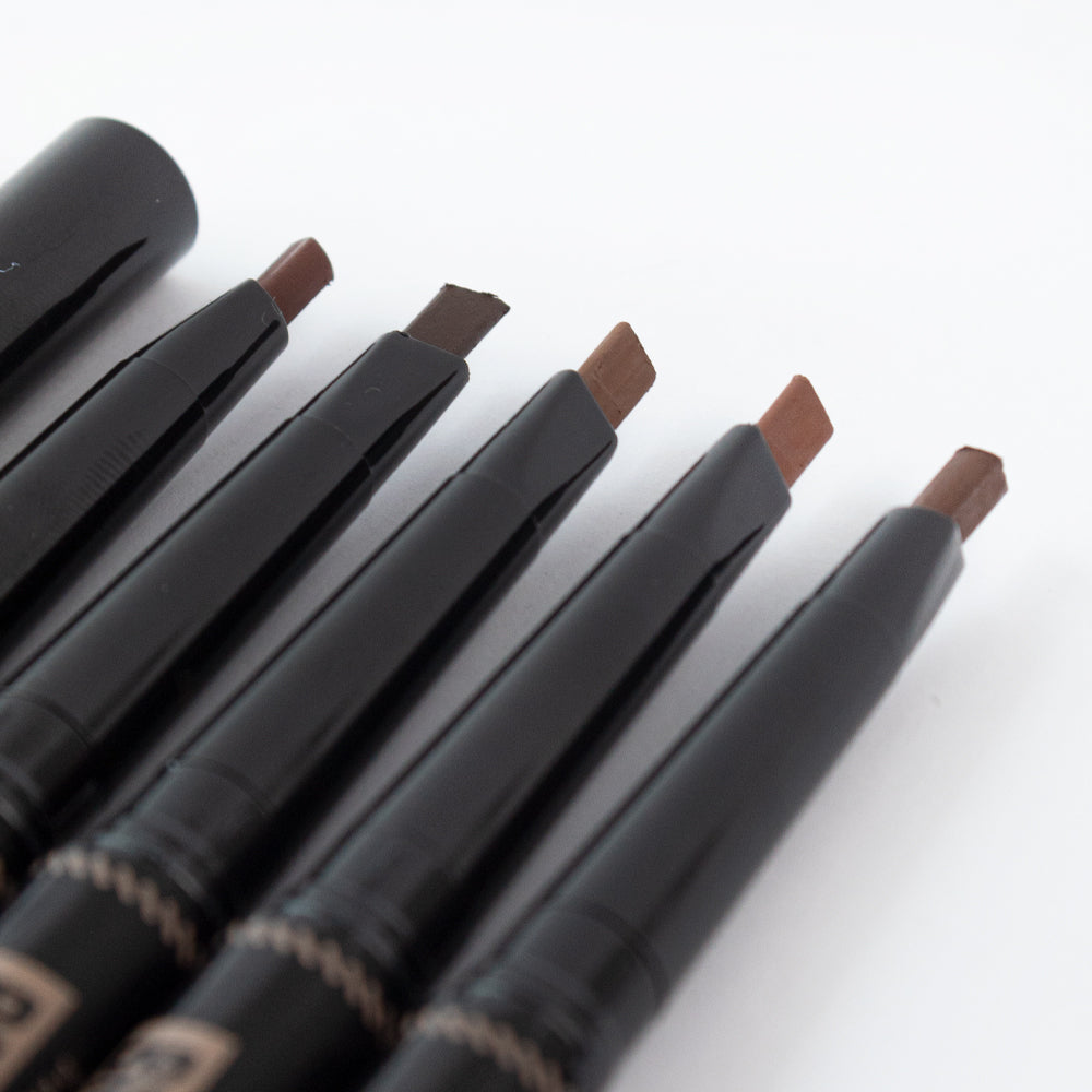 Close-up of Revel Professional Brow Natural Duo flat-tip brow pen in multiple brown shades on white background