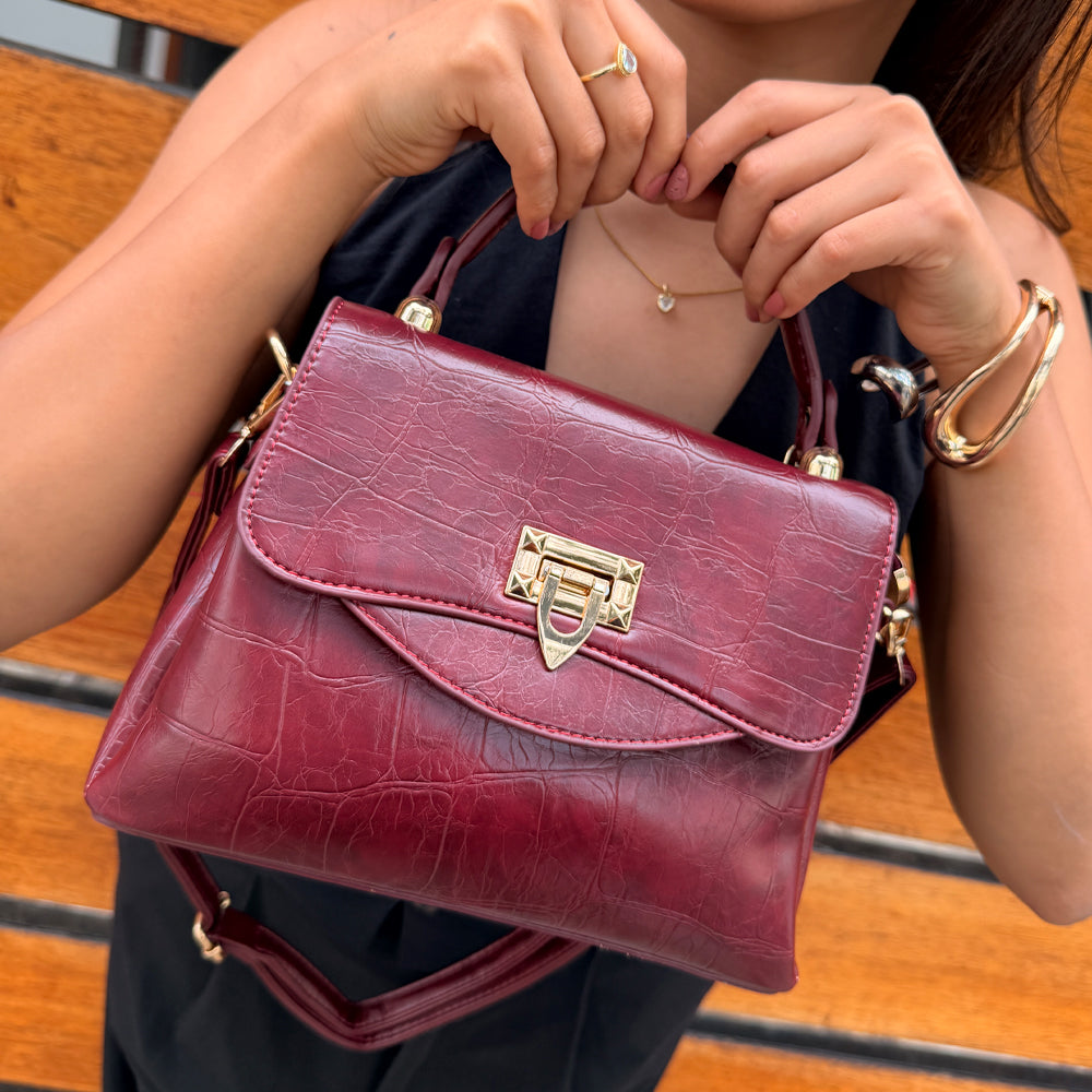 Cartera Aurora Elegance en variantes de color vino, marrón oscuro, negro y beige con textura cocodrilo y cierre dorado