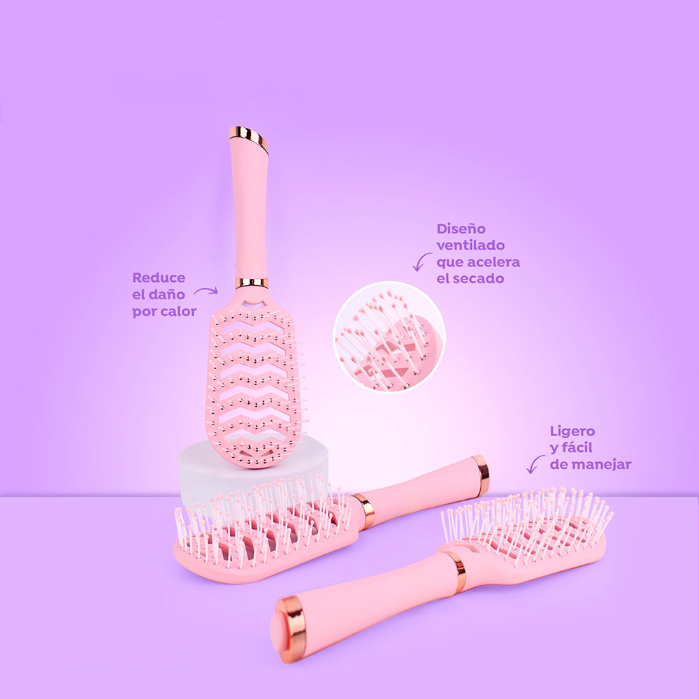 Cepillo Air Flow Pro ventilado rosa pastel con diseño chevron perforado para secado rápido y reducción de daño por calor con detalles rose gold sobre fondo lila