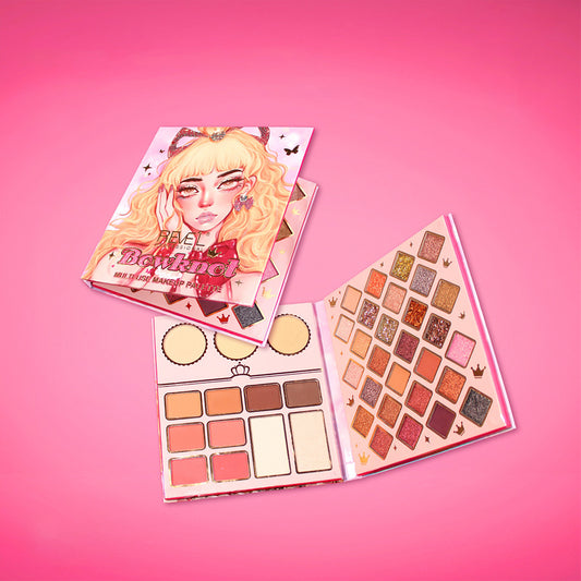 Paleta libro multiuso Bowknot de Reve'l Professional abierta con sombras glitter y matte en tonos cálidos y dorados, rubores, iluminadores y polvos compactos