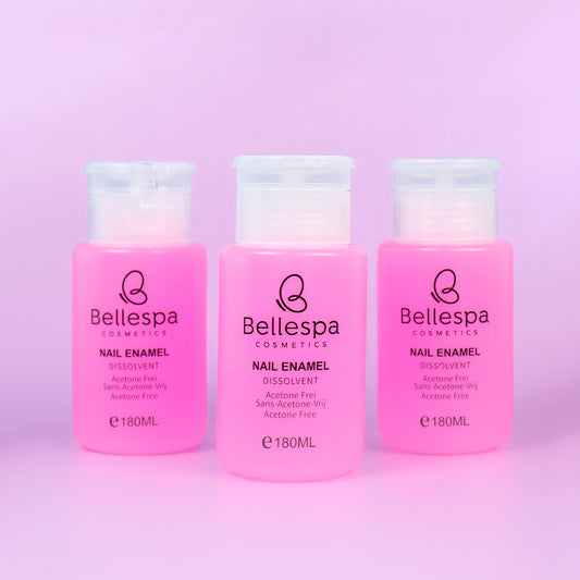 Removedor de esmalte Nail Enamel Dissolvent Acetone Free Bellespa Cosmetics en envase rosa con dispensador 180ml sobre fondo lila
