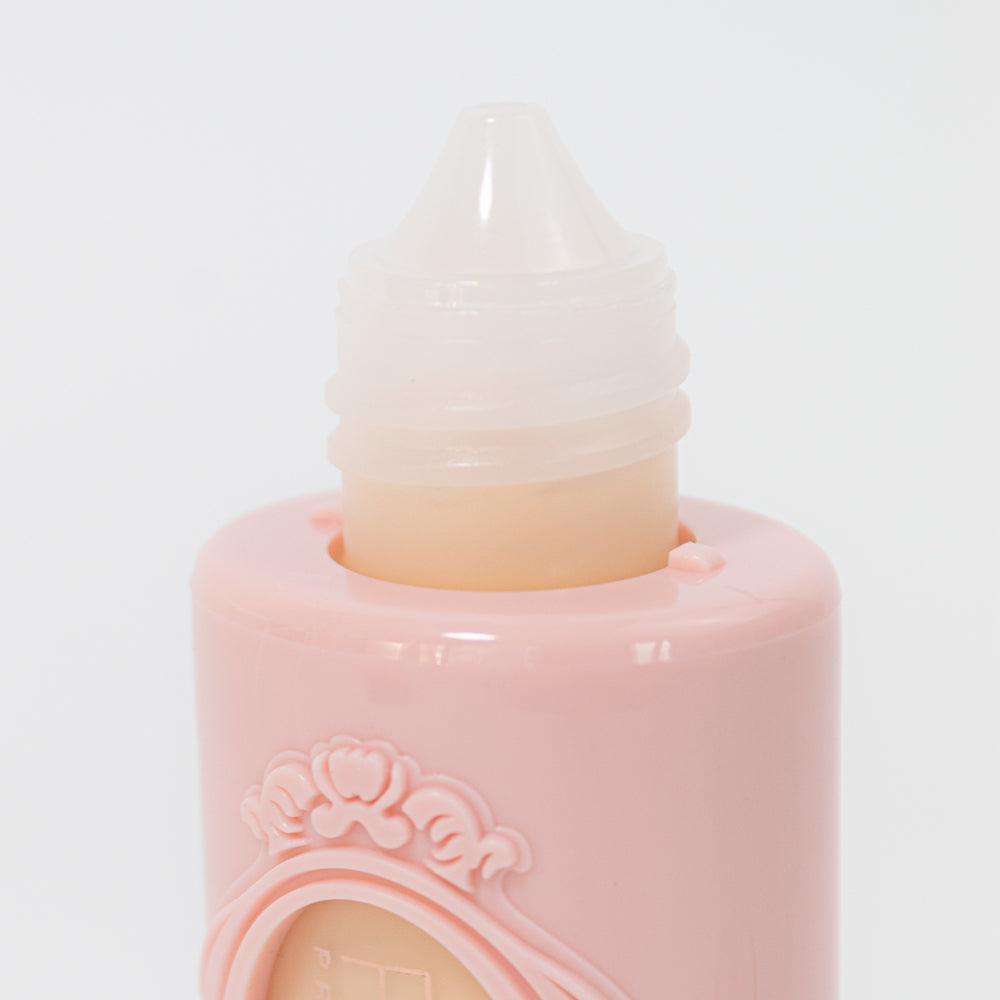 Detalle de aplicador tipo pico de base líquida crema rosa — Reve'l Professional 43 ml