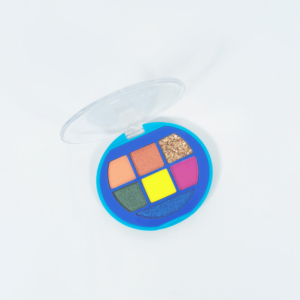 Paleta sombras Glam Eye abierta mostrando 7 tonos vibrantes glitter y shimmer en estuche redondo azul — Reve'l Professional