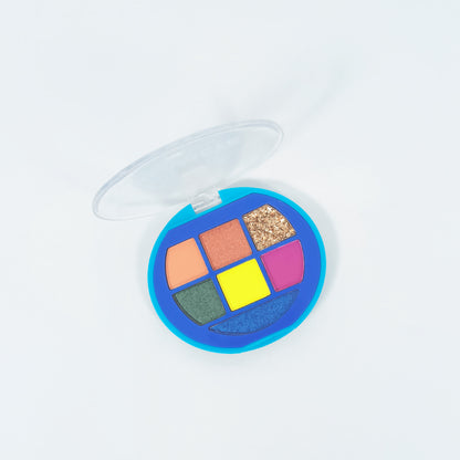 Paleta sombras Glam Eye abierta mostrando 7 tonos vibrantes glitter y shimmer en estuche redondo azul — Reve'l Professional