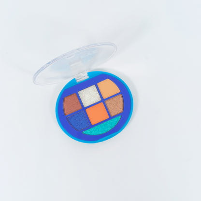 Paleta sombras Glam Eye abierta en tonos teal glitter, naranja, cobre y blanco glitter en estuche redondo azul — Reve'l Professional