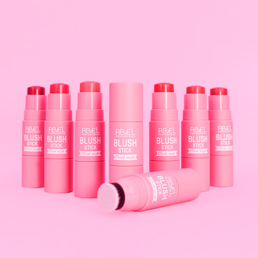 Rubor Blush Stick Cheek Rouge con brocha integrada en múltiples tonos rosa coral y rojo sobre fondo rosa — Reve'l Professional